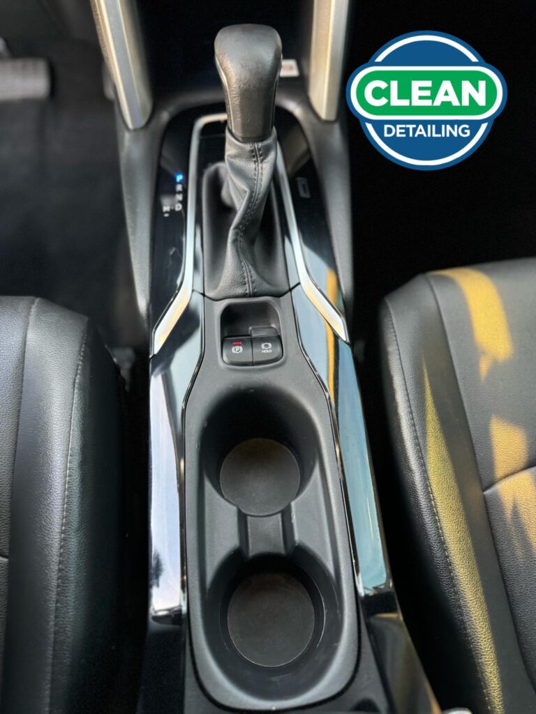 The after photo of the clean center console of a vehicle after a car detailing appointment at Clean Car Wash and Detail in Fredericksburg, VA.