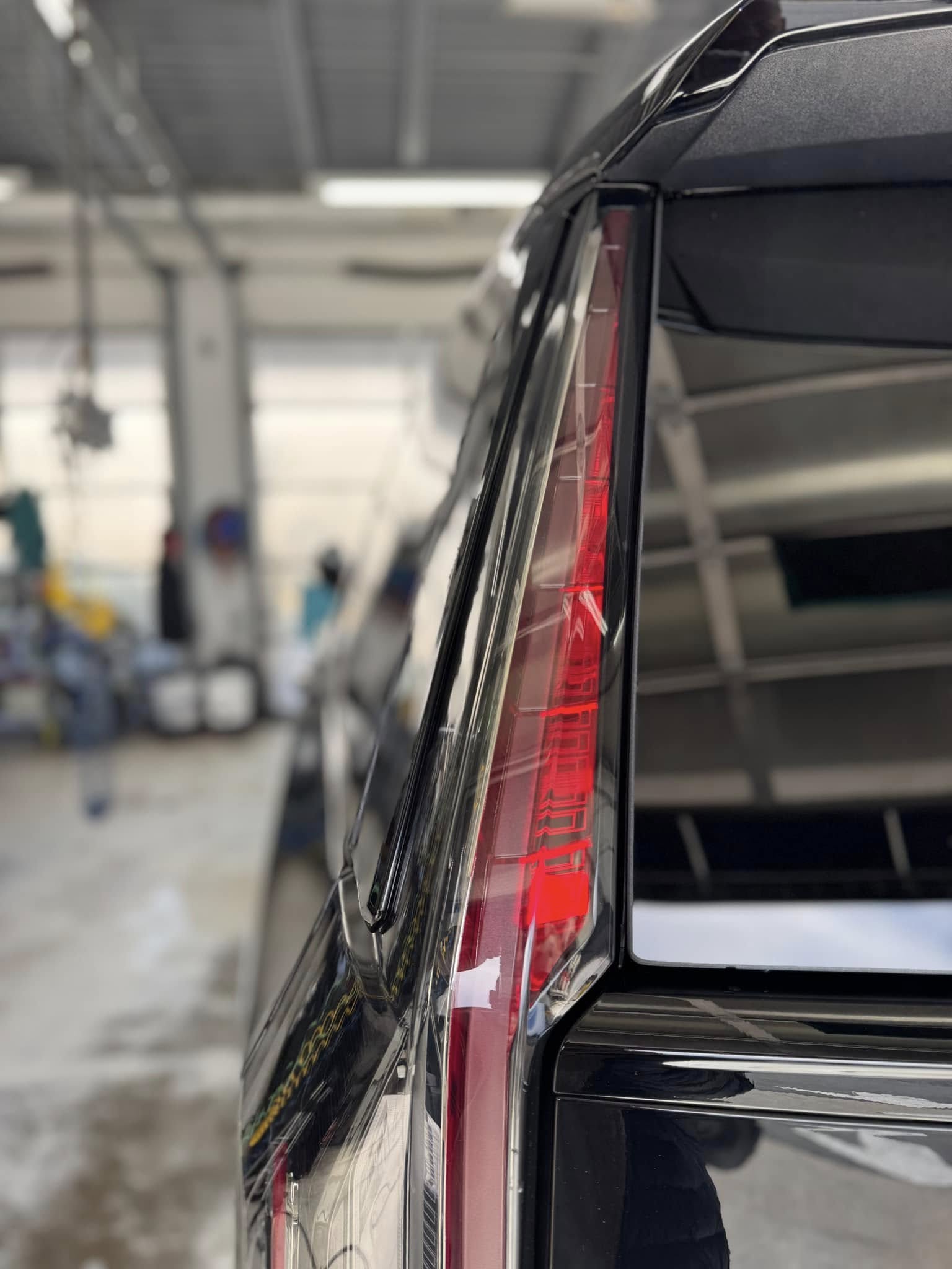 A close up of a black SUV that just finished its car detailing appointment at Clean Car Wash and Detail in Fredericksburg, VA.