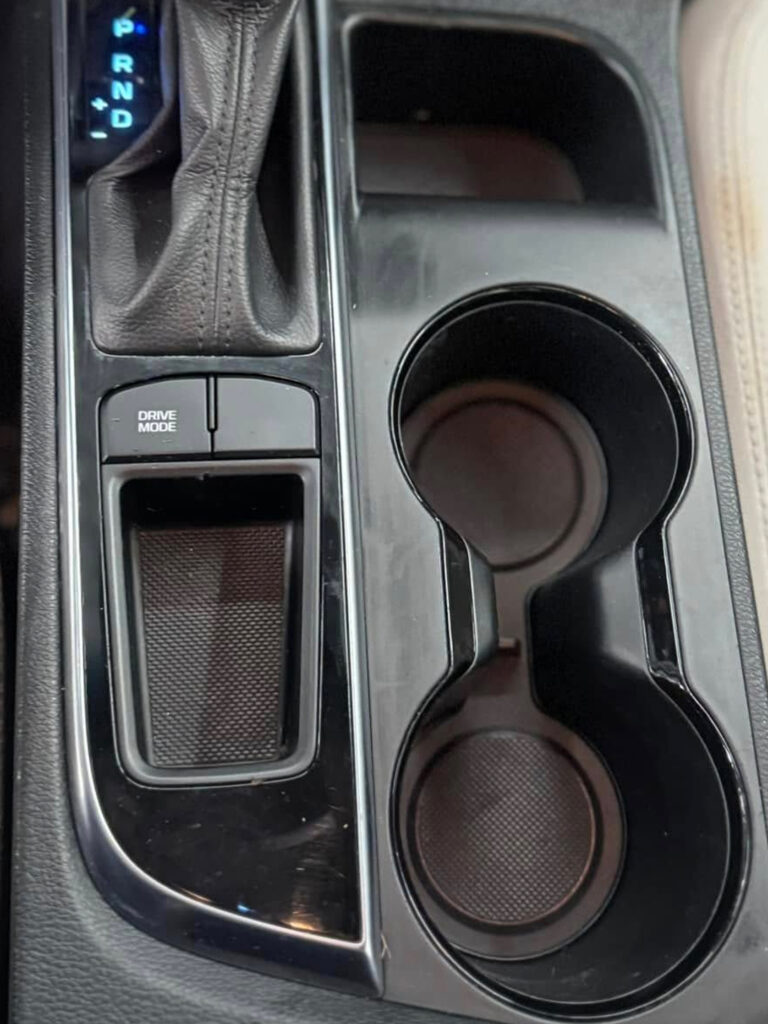 The after photo of the clean center console of a vehicle after a car detailing appointment at Clean Car Wash and Detail in Fredericksburg, VA.