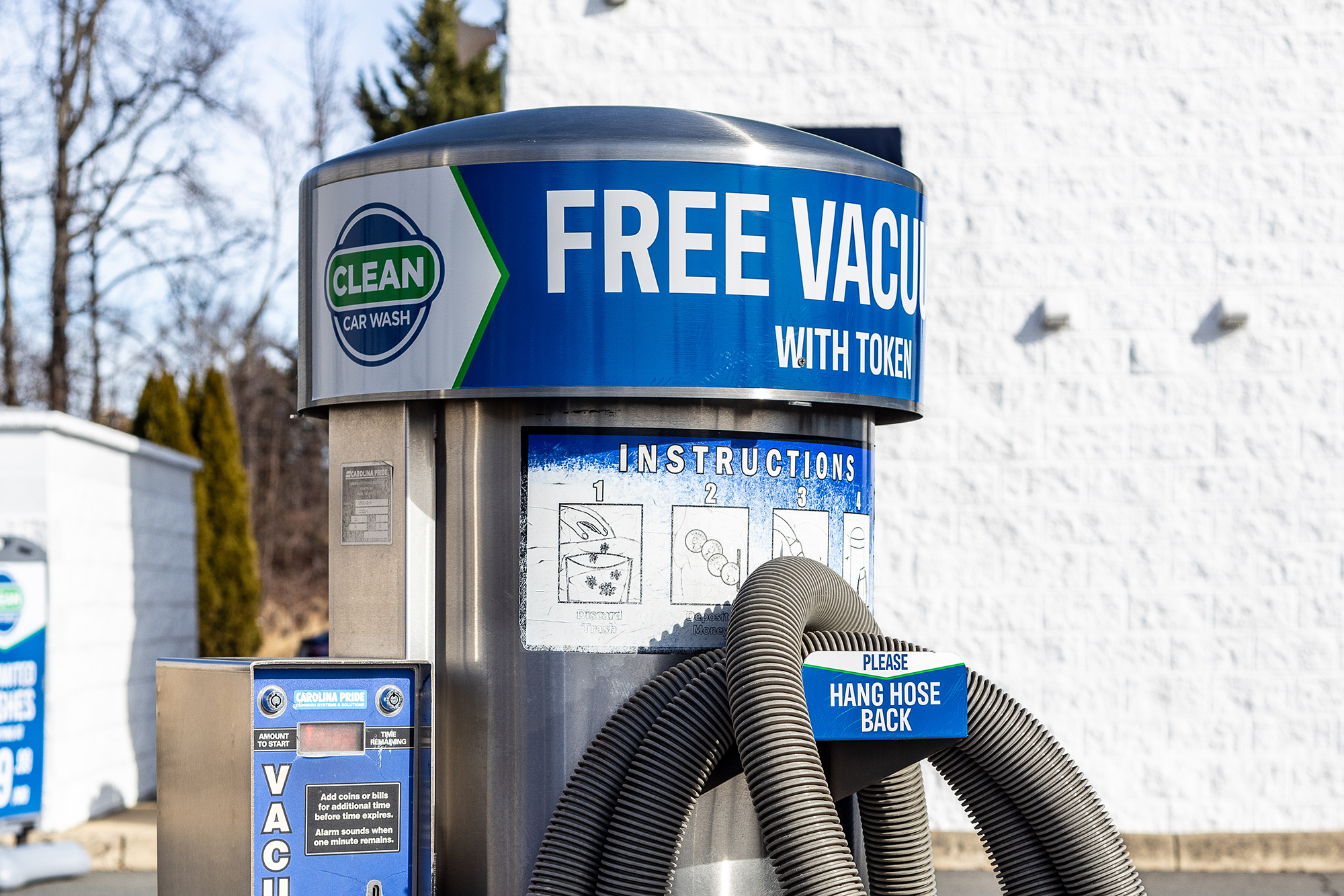 A close up of a car wash vacuum, free with the use of tokens alongside car wash memberships.
