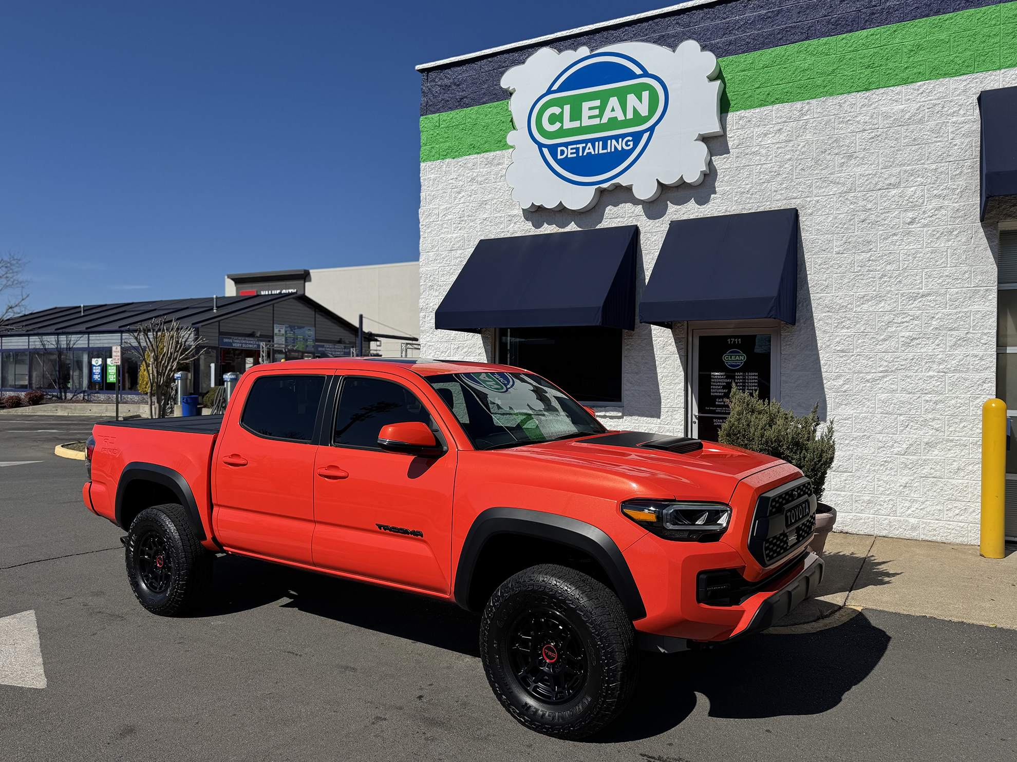 A photo of a bright orange pickup truck that received ceramic coating at Clean Car Wash and Detail in Fredericksburg, VA.