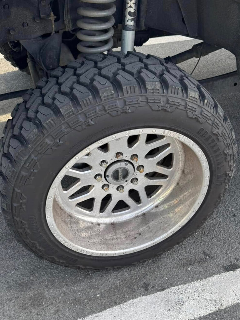 The before photo of the dirty rim of a truck at Clean Car Wash and Detail in Fredericksburg, VA.
